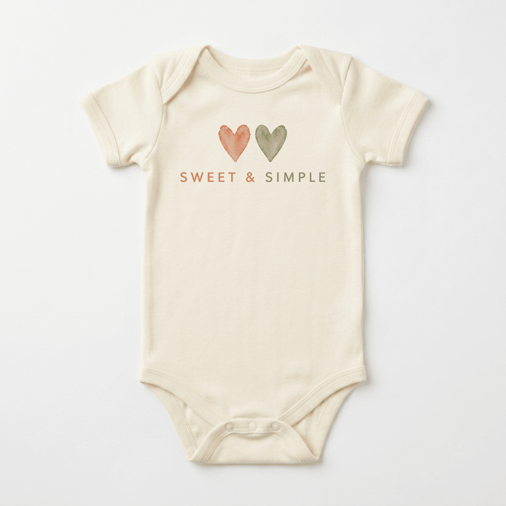 A cream-colored, gender-neutral baby onesie from Toodleroos, the Sweet & Simple Short-Sleeve Heart Bodysuit features two watercolor hearts—one orange and one green—placed above “SWEET & SIMPLE” printed in matching orange and green on the chest. This versatile piece of baby clothing makes a thoughtful shower gift for any little one.