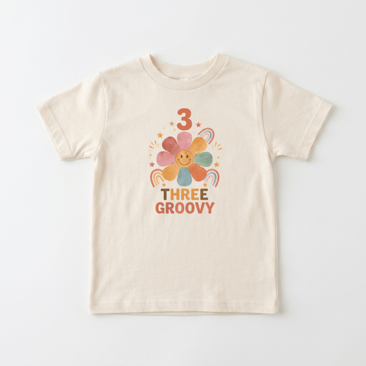 Celebrate your little one’s 3rd birthday in style with the Toodleroos 3rd Birthday Toddler Shirt – Three Groovy Retro Flower Tee, featuring a beige kids’ T-shirt decorated with a smiling flower, rainbows, stars, the number 3, and colorful “Three Groovy” retro-style lettering—perfect as a birthday shirt for toddlers or a fun retro flower tee for their special day.