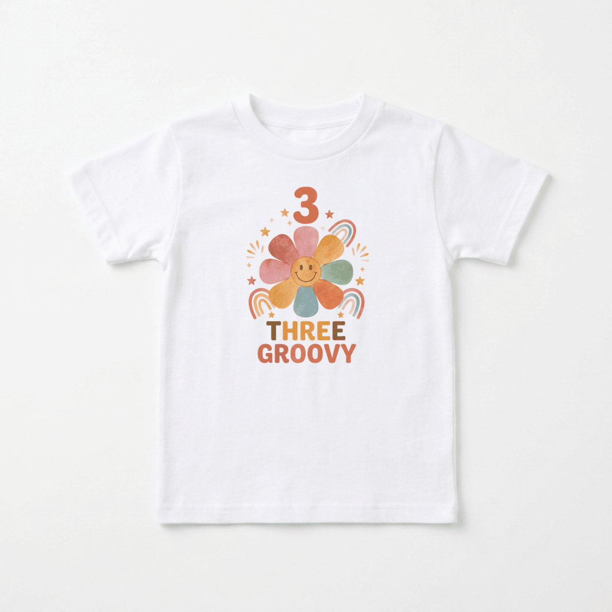 Celebrate your little one’s special day with the 3rd Birthday Toddler Shirt – Three Groovy Retro Flower Tee by Toodleroos. Featuring a white t-shirt adorned with a cheerful, multi-colored flower surrounded by rainbows and stars, this playful retro-inspired design displays the number “3” above and “THREE GROOVY” in bold orange letters below. It’s the perfect toddler birthday shirt for groovy celebrations in style!.