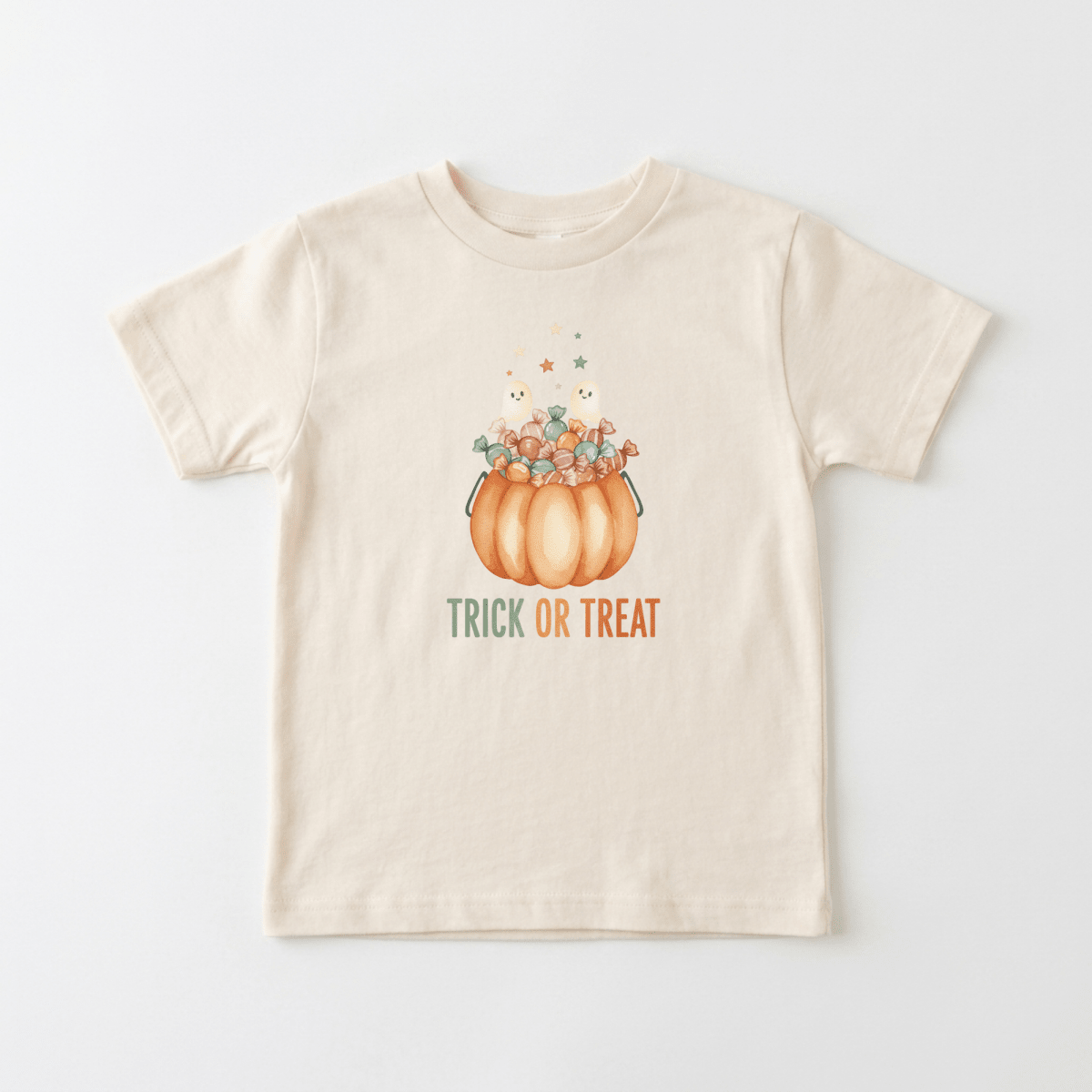 Dress your little one in Halloween style with the Toodleroos Toddler Halloween Shirt – Trick or Treat Pumpkin & Ghost Tee! This beige t-shirt features a playful pumpkin candy bucket, cheerful stars, and a friendly ghost, with “Trick or Treat” printed below in orange and green. It’s the perfect festive shirt for trick-or-treating or any Halloween celebration!.