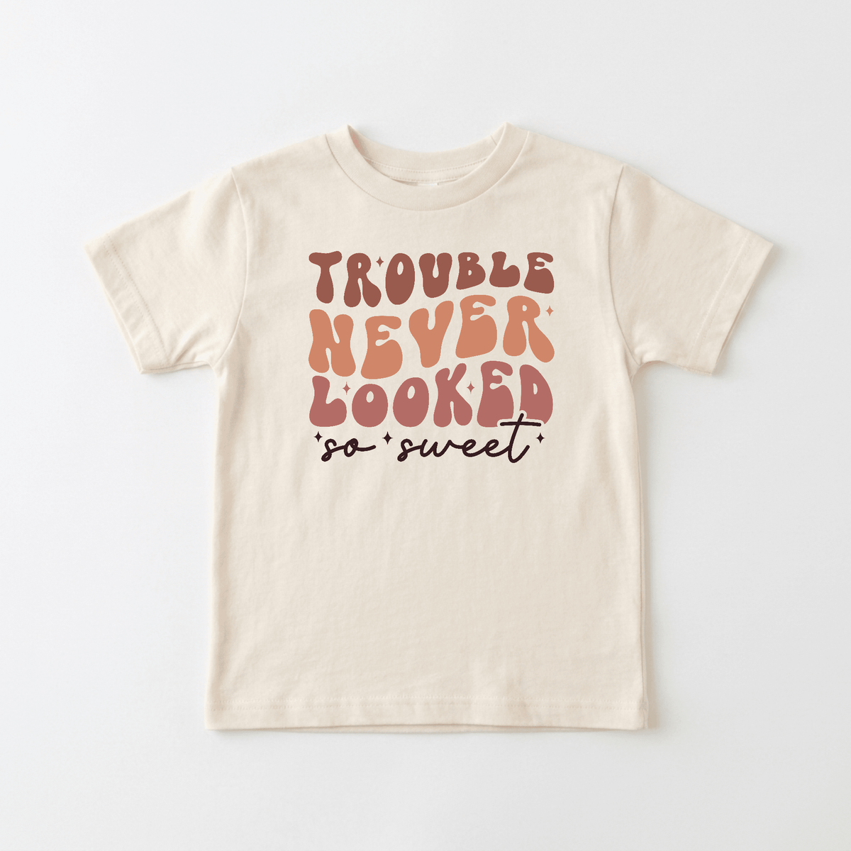 The Toodleroos Trouble Never Looked So Sweet Kids Shirt – Funny Retro Tee features playful, retro-style lettering in orange, pink, and brown on a beige background—making it the perfect retro kids shirt for little ones with big personalities.