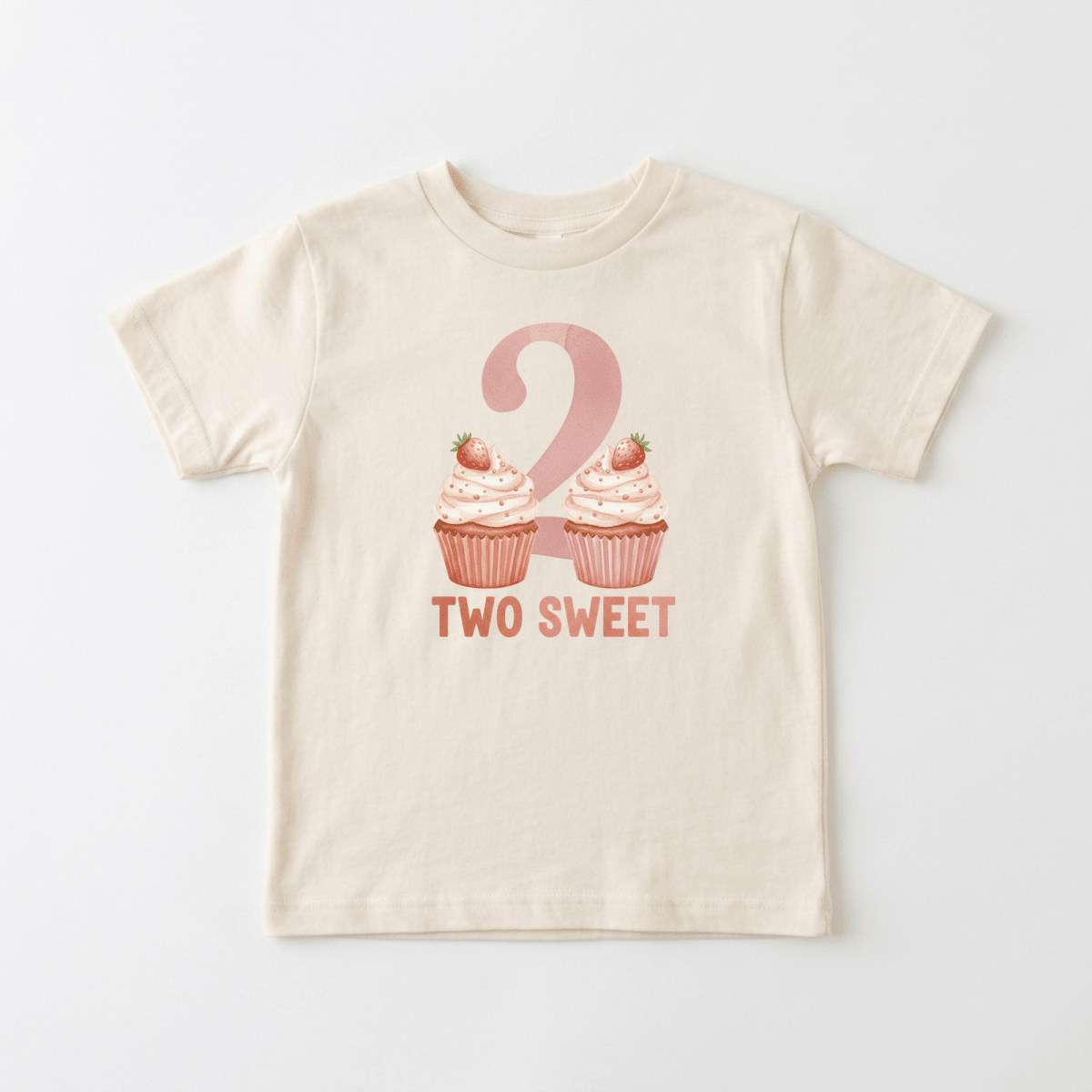 The Toodleroos 2nd Birthday Toddler Shirt – Two Sweet Cupcake Short-Sleeve Tee is a cream-colored kids T-shirt featuring the number 2 above two pink frosted cupcakes topped with strawberries, and the phrase “TWO SWEET” printed in pink below—perfect as a “two sweet” birthday shirt or adorable 2nd birthday toddler tee.