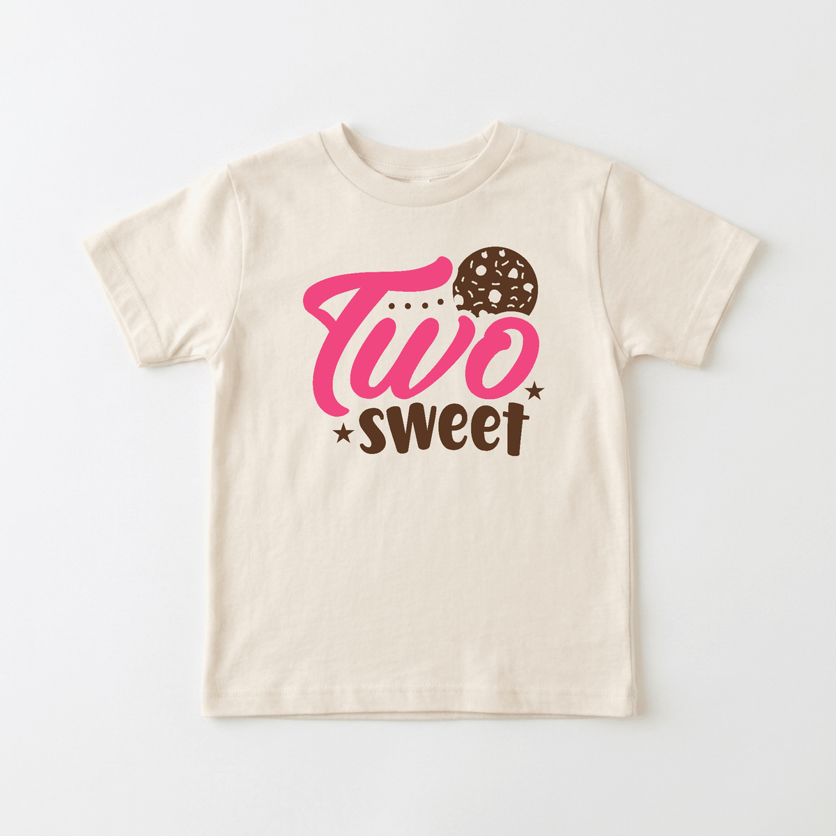 Celebrate your little one’s 2nd birthday with the Toodleroos Two Sweet Toddler Shirt – Cookie 2nd Birthday Tee, featuring “Two Sweet” in pink and brown lettering and a playful cookie design above the word “sweet”—a perfect choice for a two sweet birthday celebration.