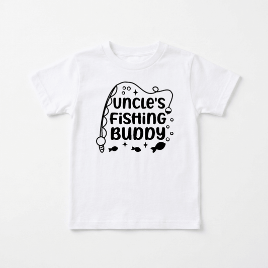 Introducing the Toodleroos Uncle’s Fishing Buddy Toddler Boys Shirt – Fishing Rod Tee! This white shirt features bold black text that reads “Uncles Fishing Buddy,” complete with playful fishing pole, bubbles, and cute fish graphics surrounding the lettering. Perfect as a toddler fishing tee or a heartfelt Father’s Day gift, this Toodleroos shirt is ideal for creating special family memories by the water.