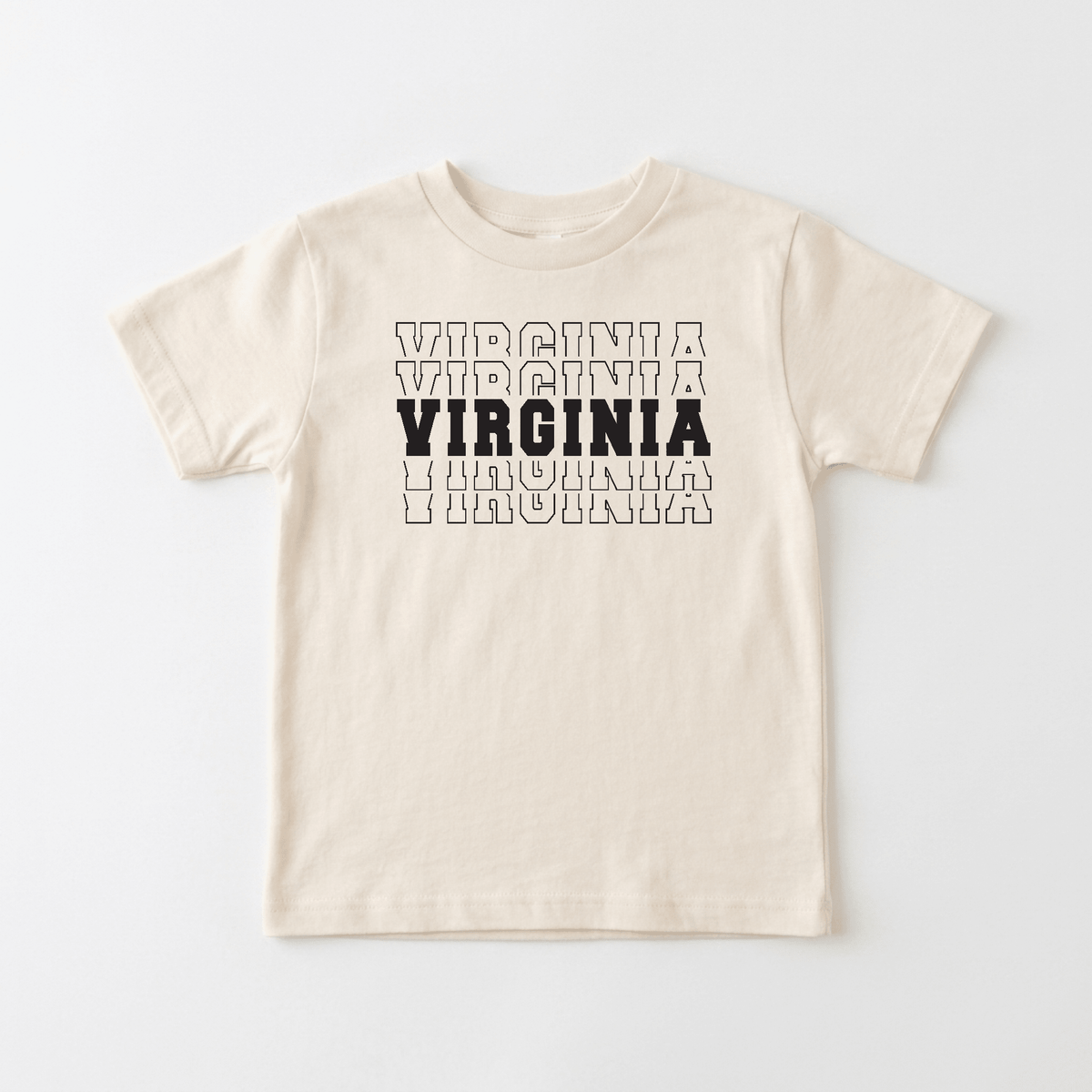 Introducing the Virginia Varsity Toddler Shirt – Kids State Pride Tee by Toodleroos: a beige shirt featuring “VIRGINIA” printed three times in a stacked, varsity-style graphic. The middle word stands out in bold black, with the top and bottom outlined in black—perfect for little ones to show off their hometown pride.