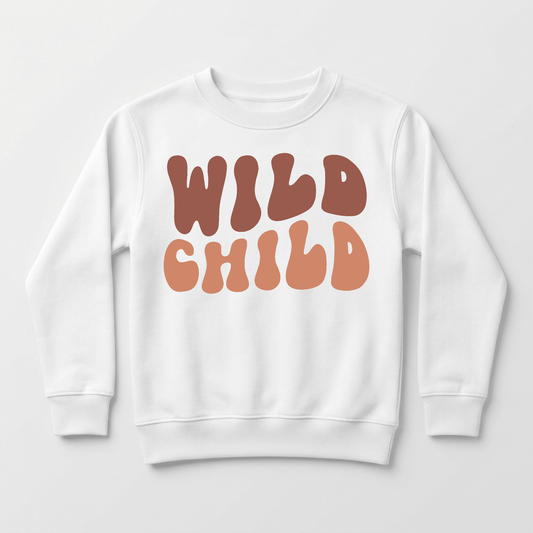 The Toodleroos Wild Child Kids Sweatshirt – Boho Retro Pullover is a cozy white fleece sweatshirt for kids, featuring “WILD CHILD” printed across the front in large, retro-style wavy brown and orange letters.