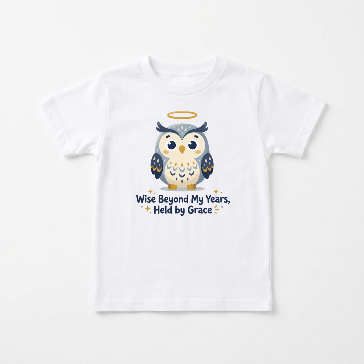 The Wise Beyond My Years Owl Kids Shirt – Faith Tee by Toodleroos features a white t-shirt adorned with a cartoon owl sporting a yellow halo above its head. Beneath the owl, the shirt displays the text: “Wise Beyond My Years, Held by Grace,” surrounded by small stars. This charming and uplifting faith-inspired design makes it a standout addition to any collection of Christian kids shirts.