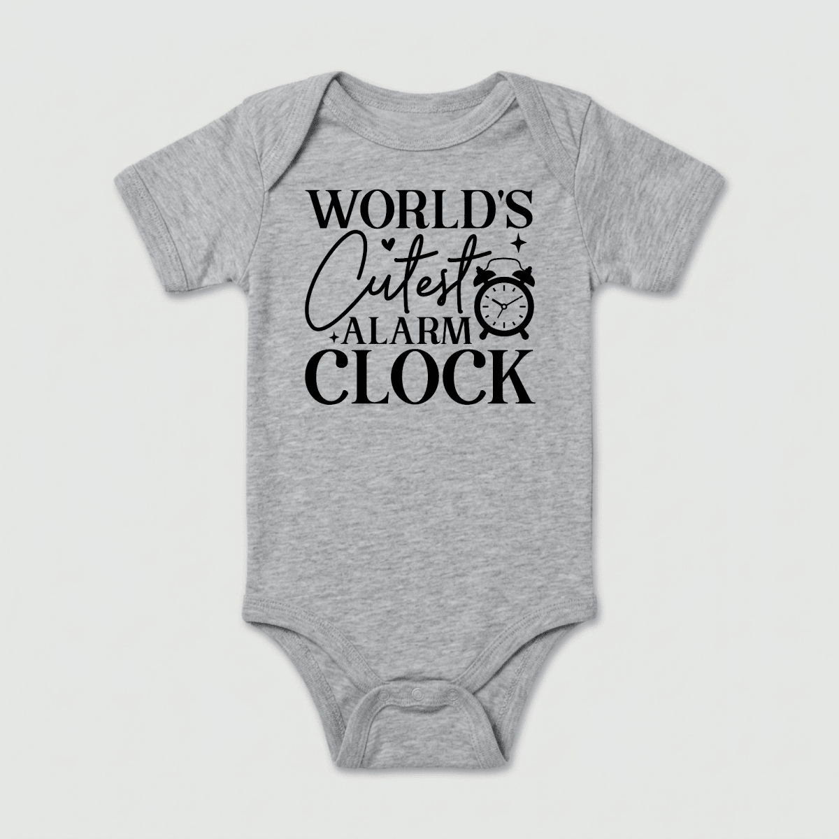 Dress your little one in the World’s Cutest Alarm Clock Onesie – Funny Baby Bodysuit by Toodleroos, a gray unisex baby outfit featuring bold black text reading “WORLDS CUTEST ALARM CLOCK” with an adorable alarm clock graphic beside the word “CUTEST.” This charming bodysuit makes an ideal baby shower gift for new parents.