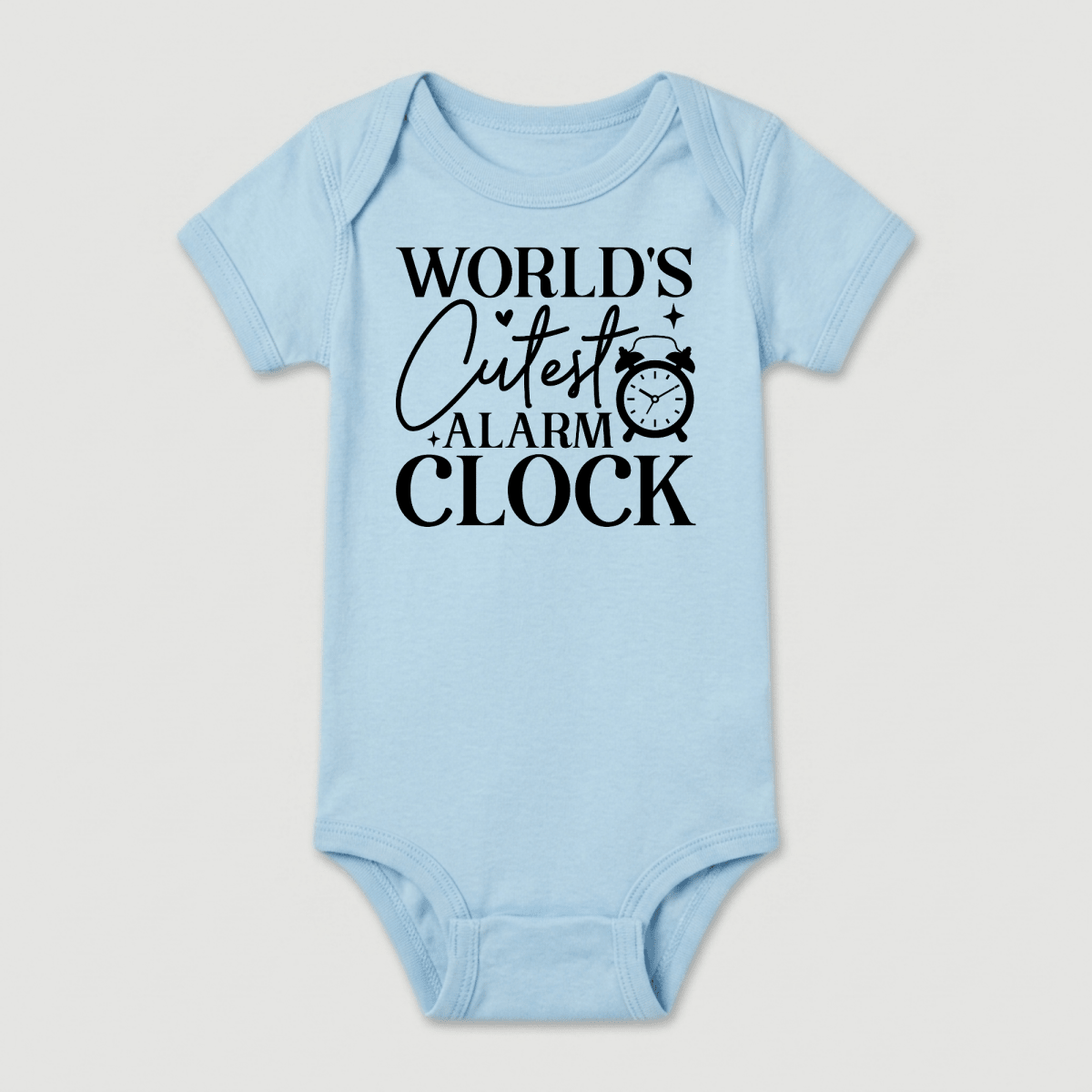 Dress your little one in the Toodleroos World’s Cutest Alarm Clock Onesie – Funny Baby Bodysuit, featuring light blue fabric and bold black text that says “WORLDS CUTEST ALARM CLOCK” alongside a cute clock illustration next to the word “cutest.” This adorable unisex onesie is a delightful baby shower gift for new parents.