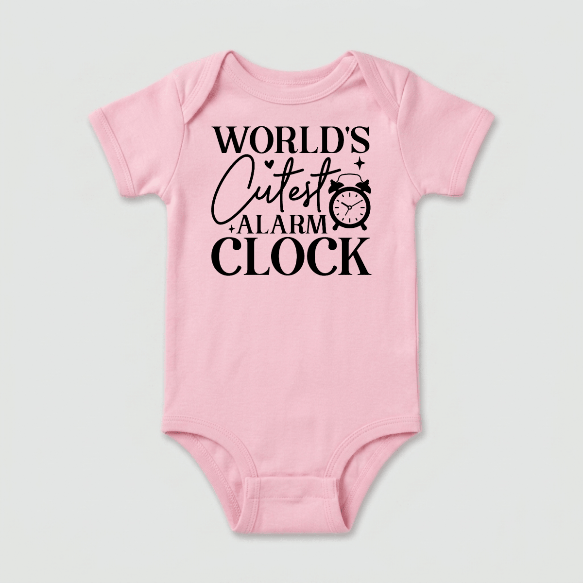 The Toodleroos World’s Cutest Alarm Clock Onesie – Funny Baby Bodysuit is a pink unisex baby onesie featuring black text that says “WORLDS CUTEST ALARM CLOCK” alongside a small alarm clock illustration near the word “CUTEST.” This humorous Toodleroos bodysuit makes a perfect baby shower gift for new parents.