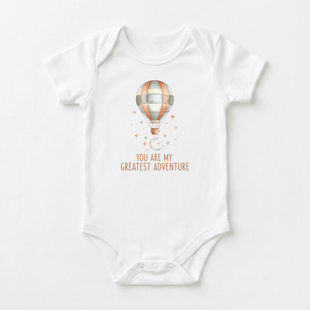 Dress your little one in the Toodleroos You Are My Greatest Adventure Baby Onesie – Hot Air Balloon, featuring a whimsical watercolor hot air balloon soaring above the heartfelt phrase “You are my greatest adventure,” surrounded by delicate stars and a crescent moon. This adventure-themed baby bodysuit makes a thoughtful gift for welcoming a new arrival.