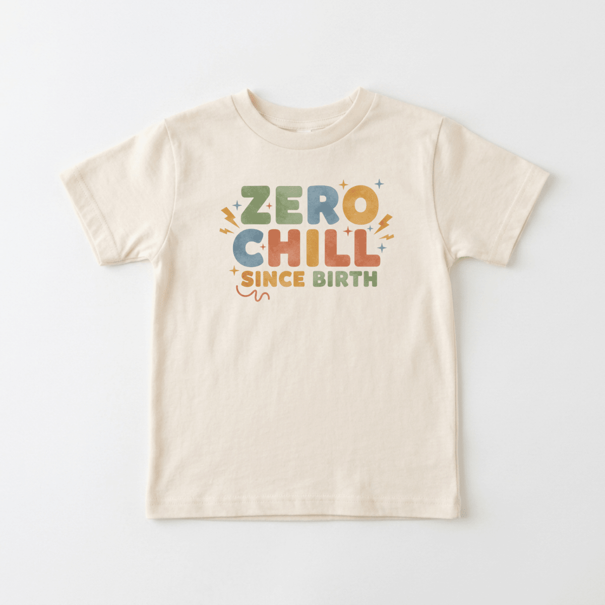 The Zero Chill Since Birth Toddler Shirt – Funny Retro Tee by Toodleroos features cheerful colors on a cream background, with playful text that reads “Zero Chill Since Birth” and is accented by small lightning bolts and squiggly lines—making this vintage-inspired Toodleroos toddler shirt a perfect pick for little ones with big personalities.